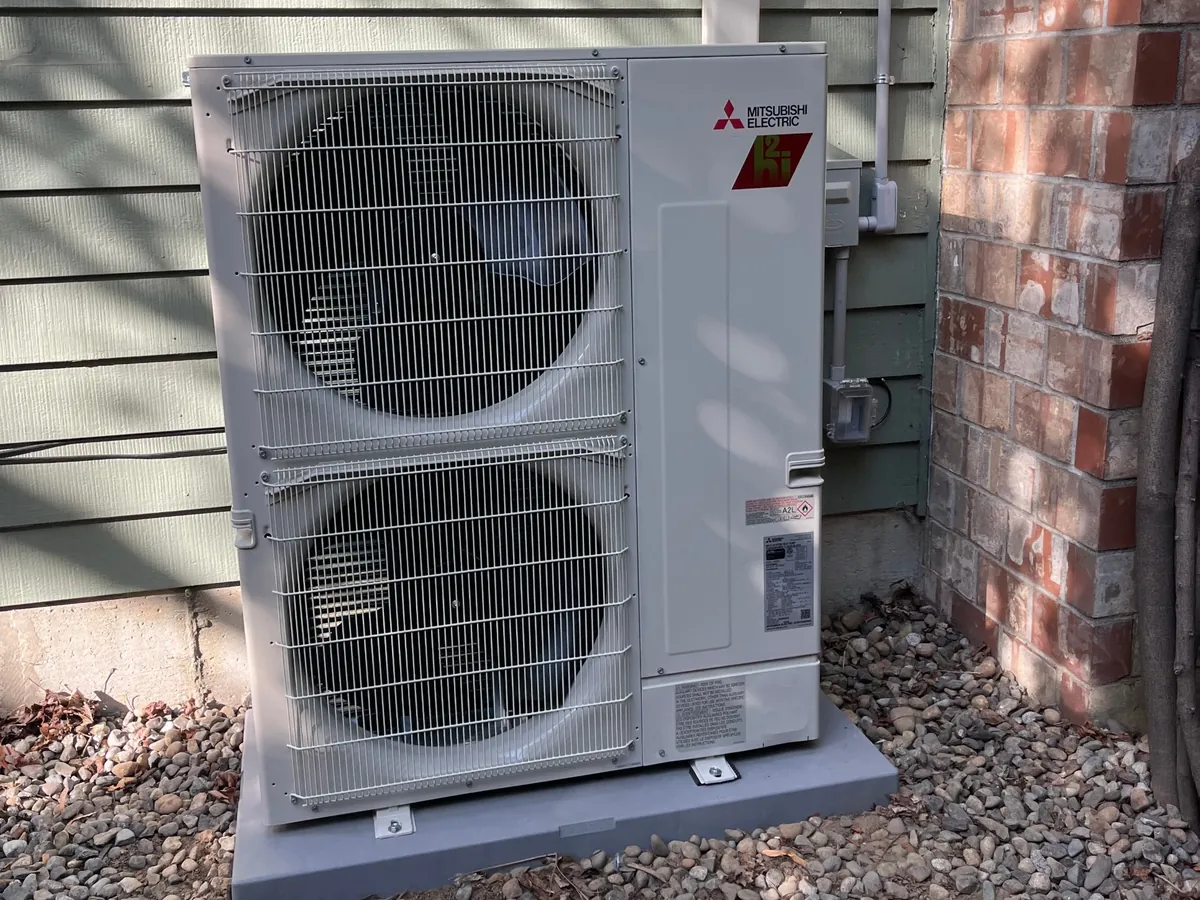 Mitsubishi Hyper-Heat outdoor unit on river rock at a Bellevue home