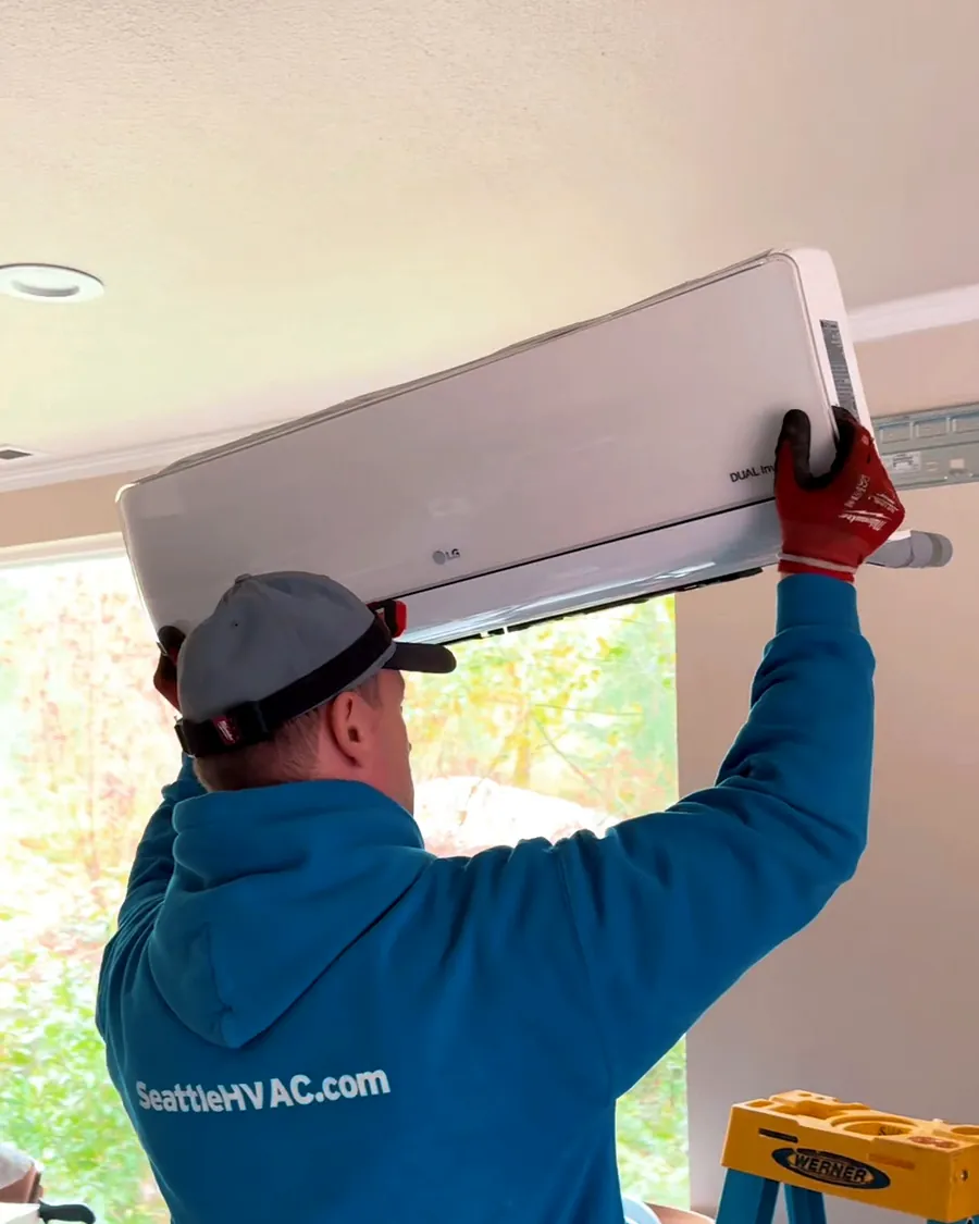 Seattle Heating & Cooling tech hanging a new ductless mini-split head