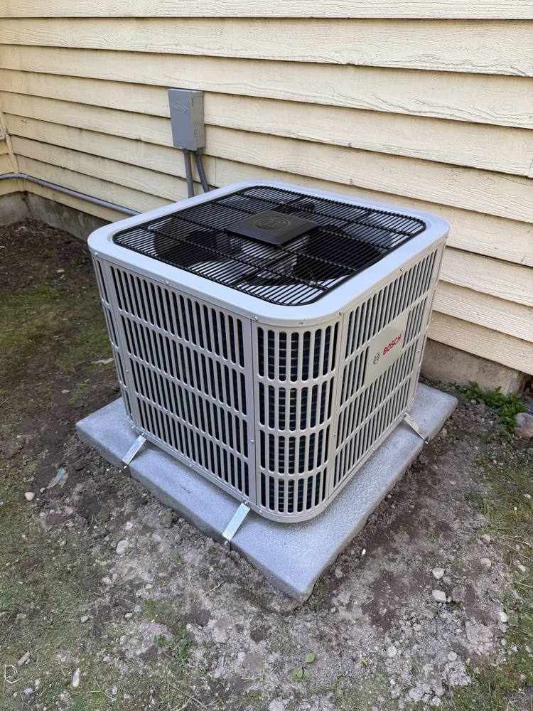 Heat pump outdoor unit on a new pad at a Kirkland home