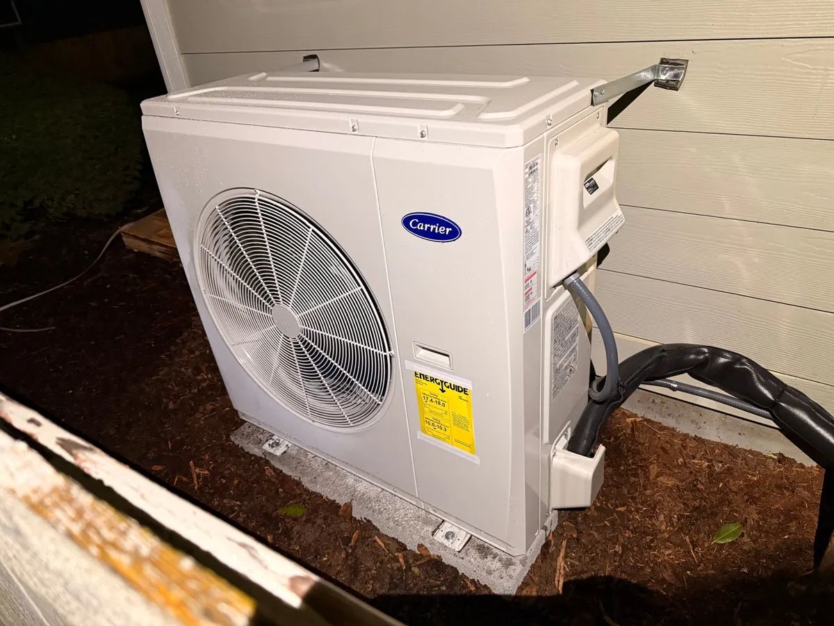 Heat pump outdoor unit on a new pad at a Newcastle home