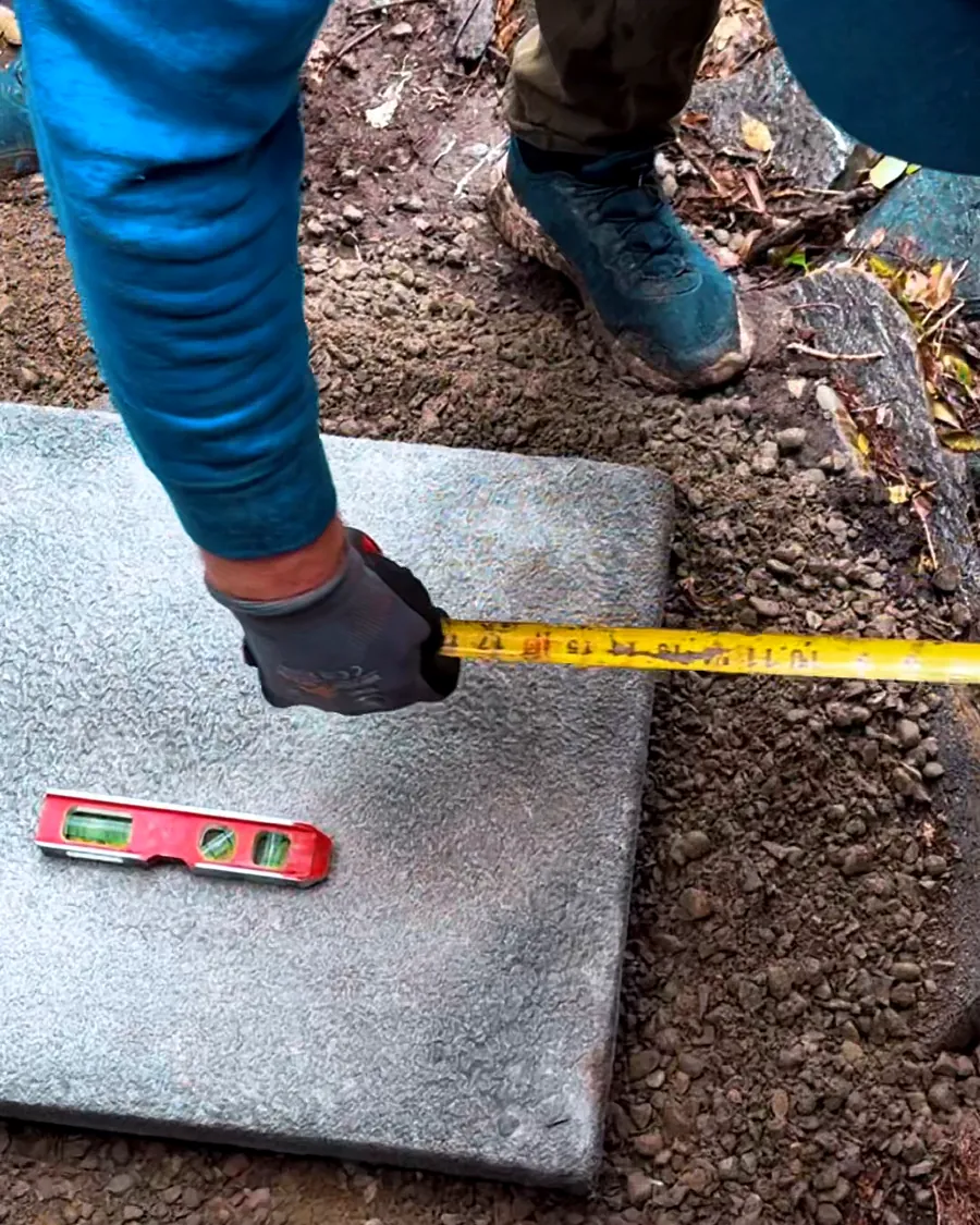 Technician measuring and leveling a new equipment pad