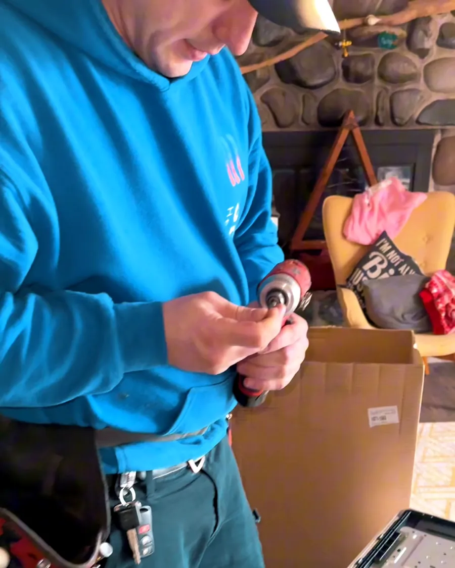 Technician preparing a ductless mounting plate inside a customer's home