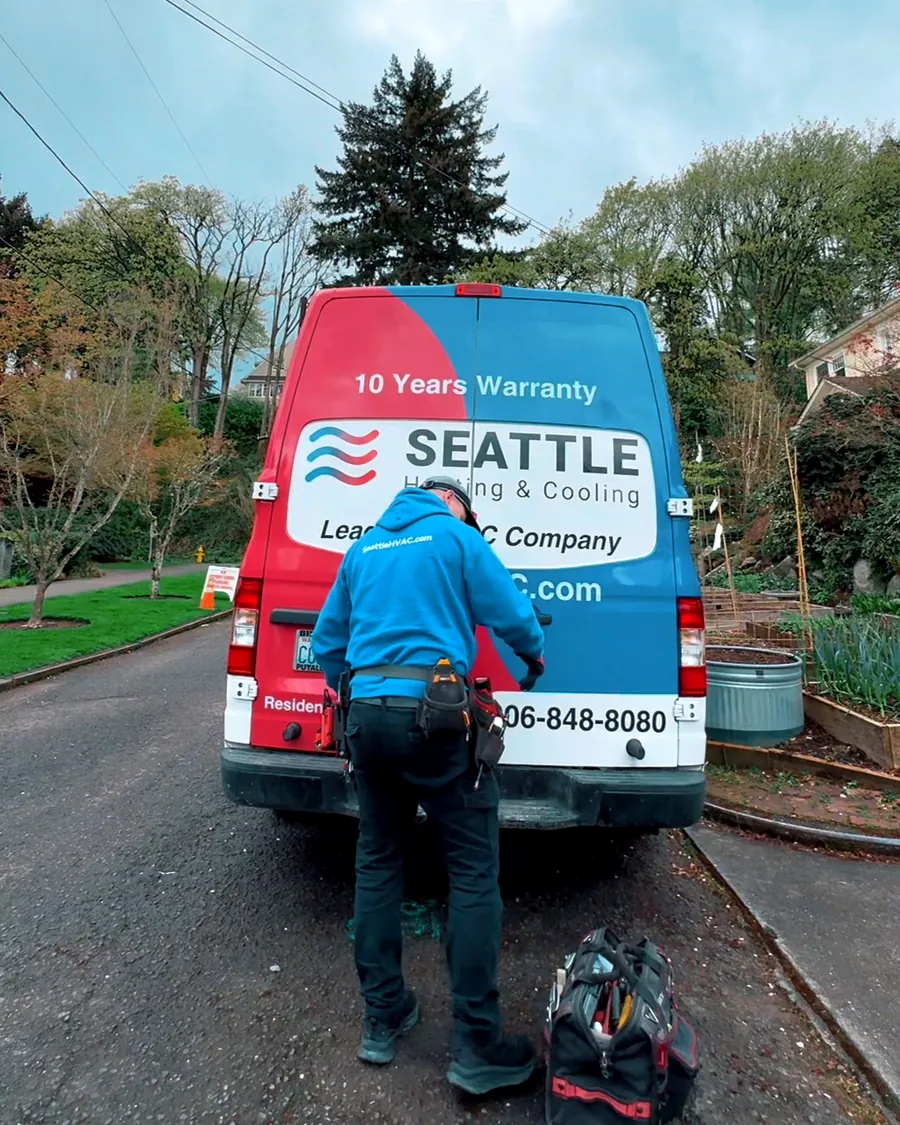 Seattle Heating & Cooling technician at the company van on a Seattle street