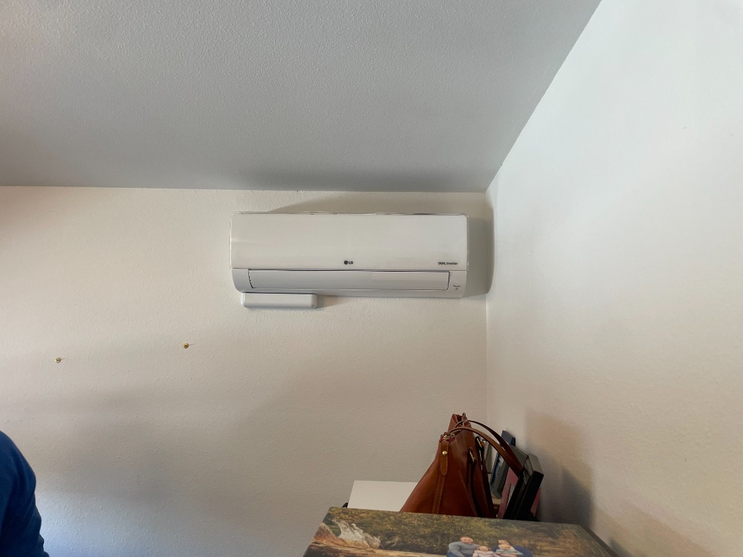 seattle heating cooling services by product lg Kirkland - Seattle Heating & Cooling A white split air conditioning unit is mounted on a plain wall above a table with handbags and picture frames.