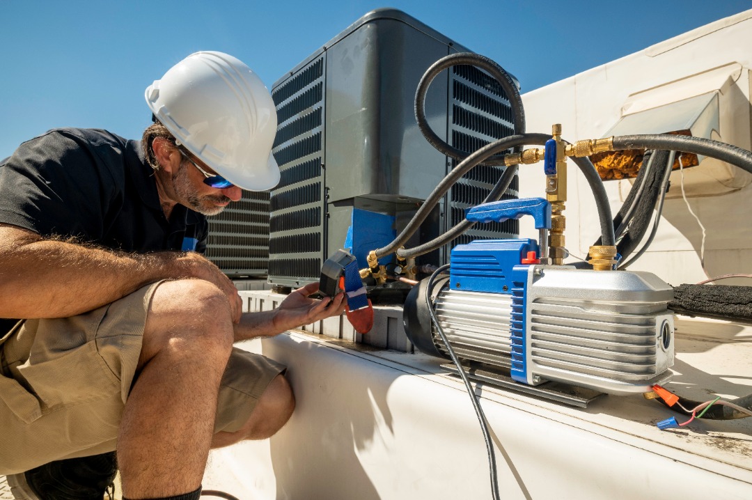 An expert ensuring a new AC unit is ready to go.