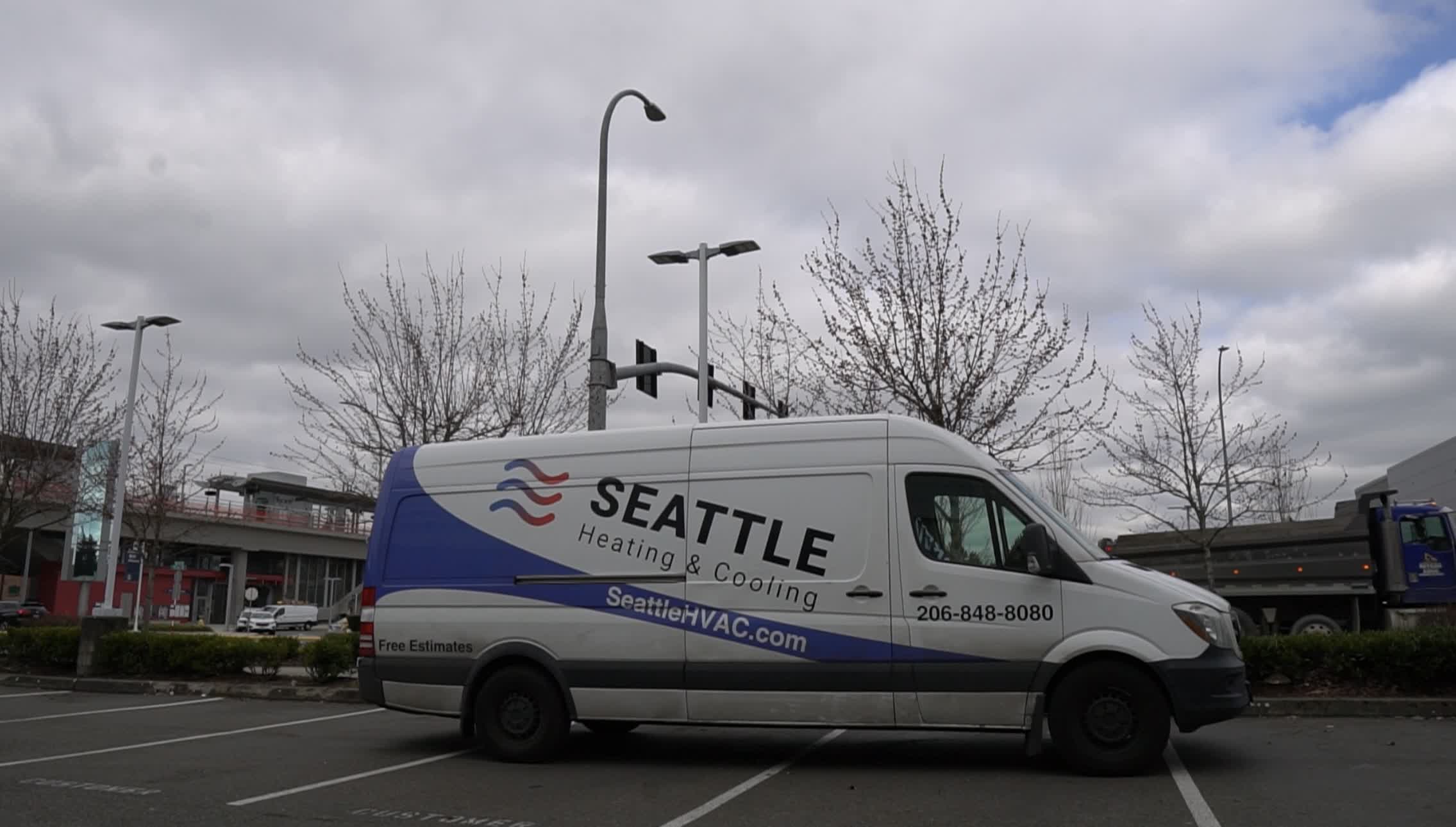 seattle heating cooling kent hvac repair services commercial hvac service - Seattle Heating & Cooling Seattle Heating & Cooling service van parked under a cloudy sky, branded with the company website and contact information.