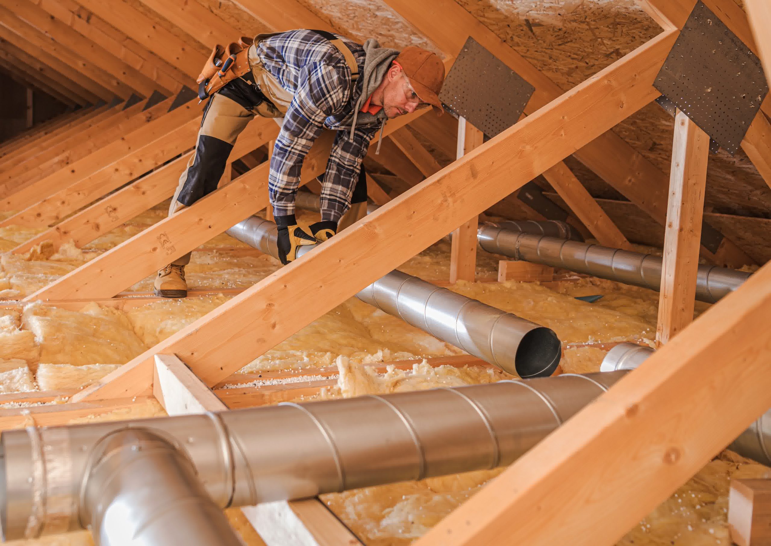 An expert HVAC technician repairing an air duct.
