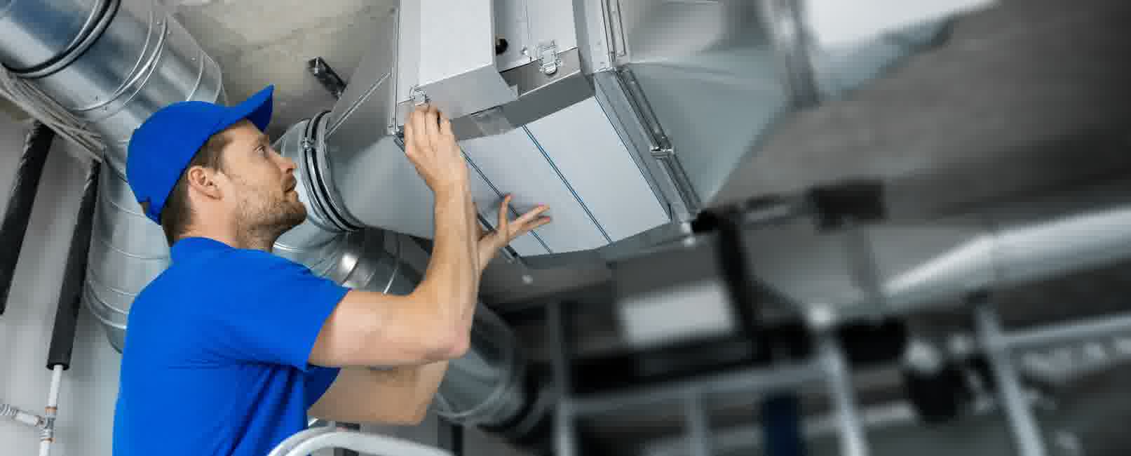 An expert HVAC technician wrapping up a duct repair service.